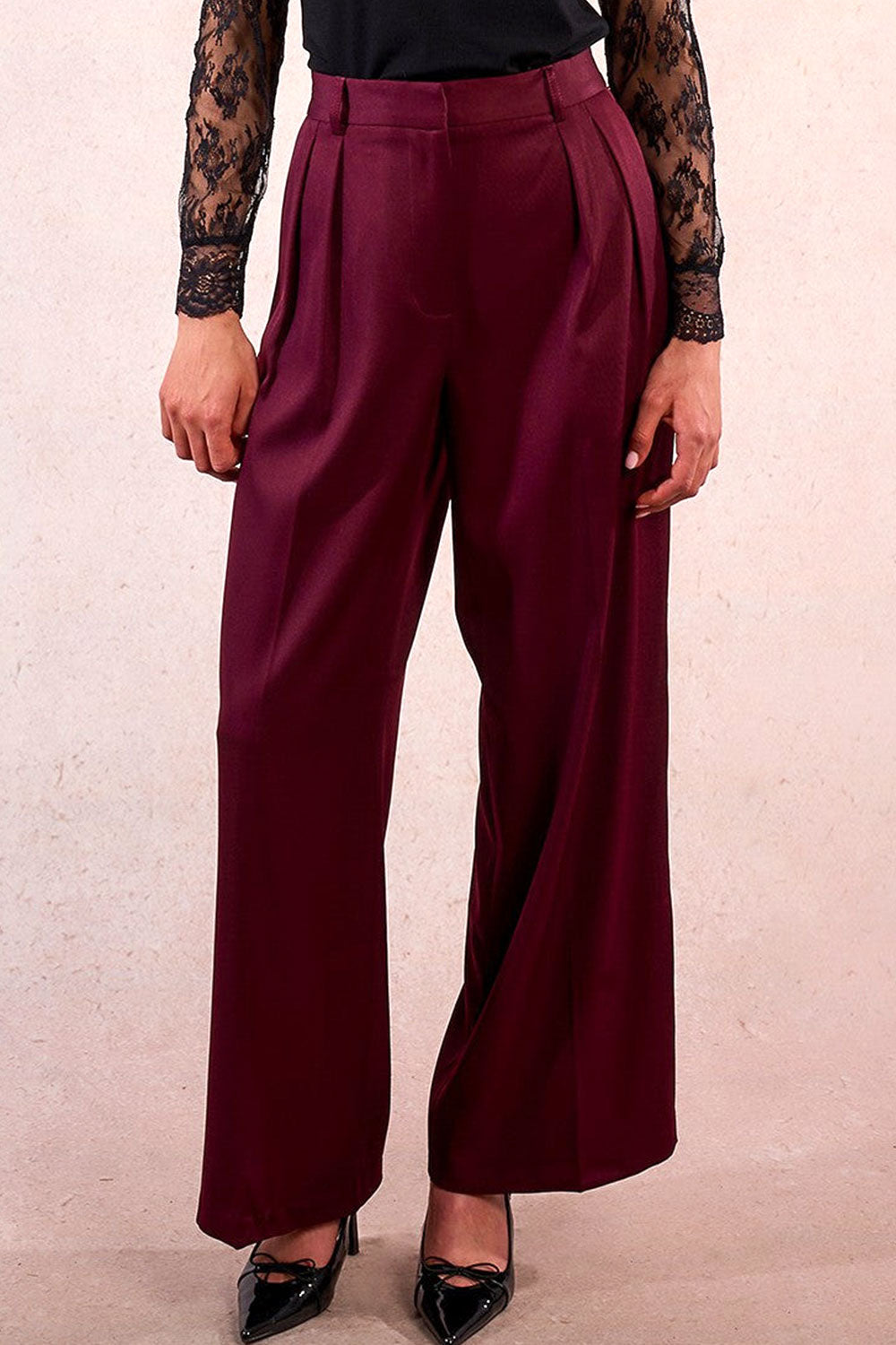 person wearing Rialto High-Waisted Pleated Burgundy Pants from La petite garçonne front