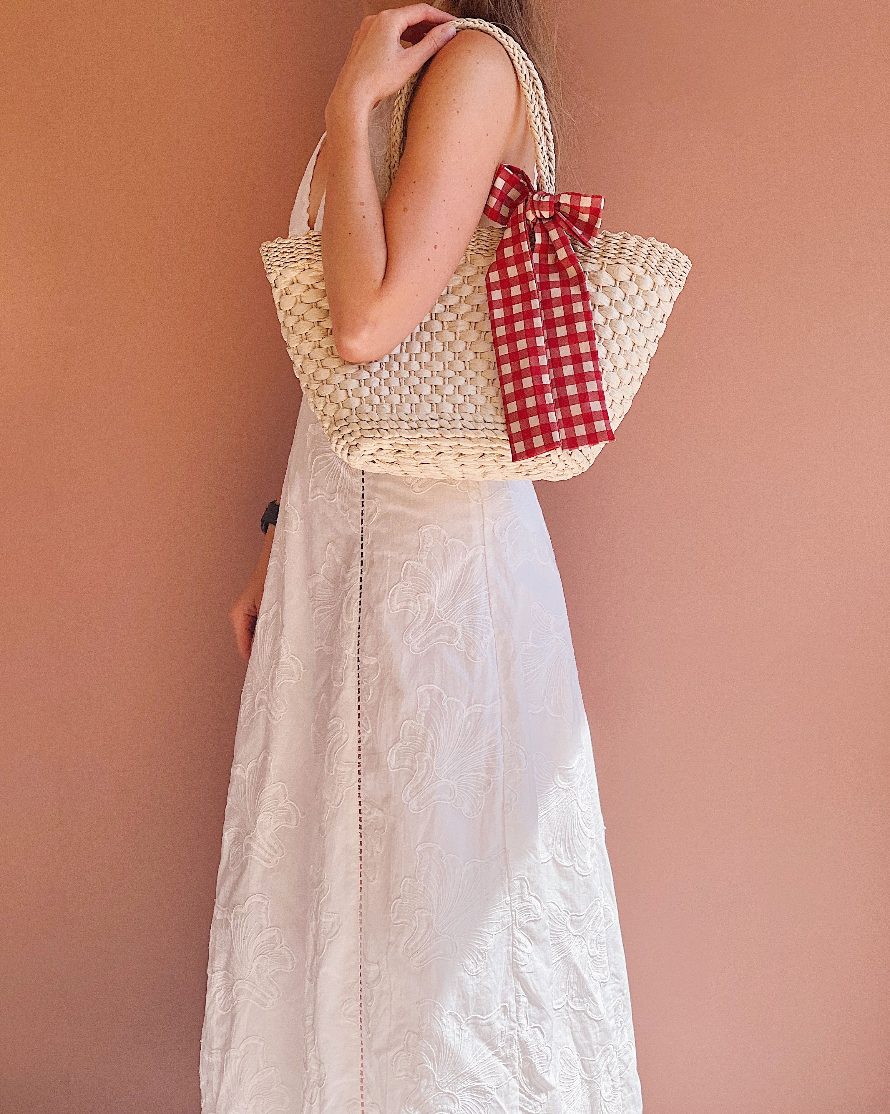 woman wearing Ripple Woven Straw Handbag with Checkered Bow from boutique 1861