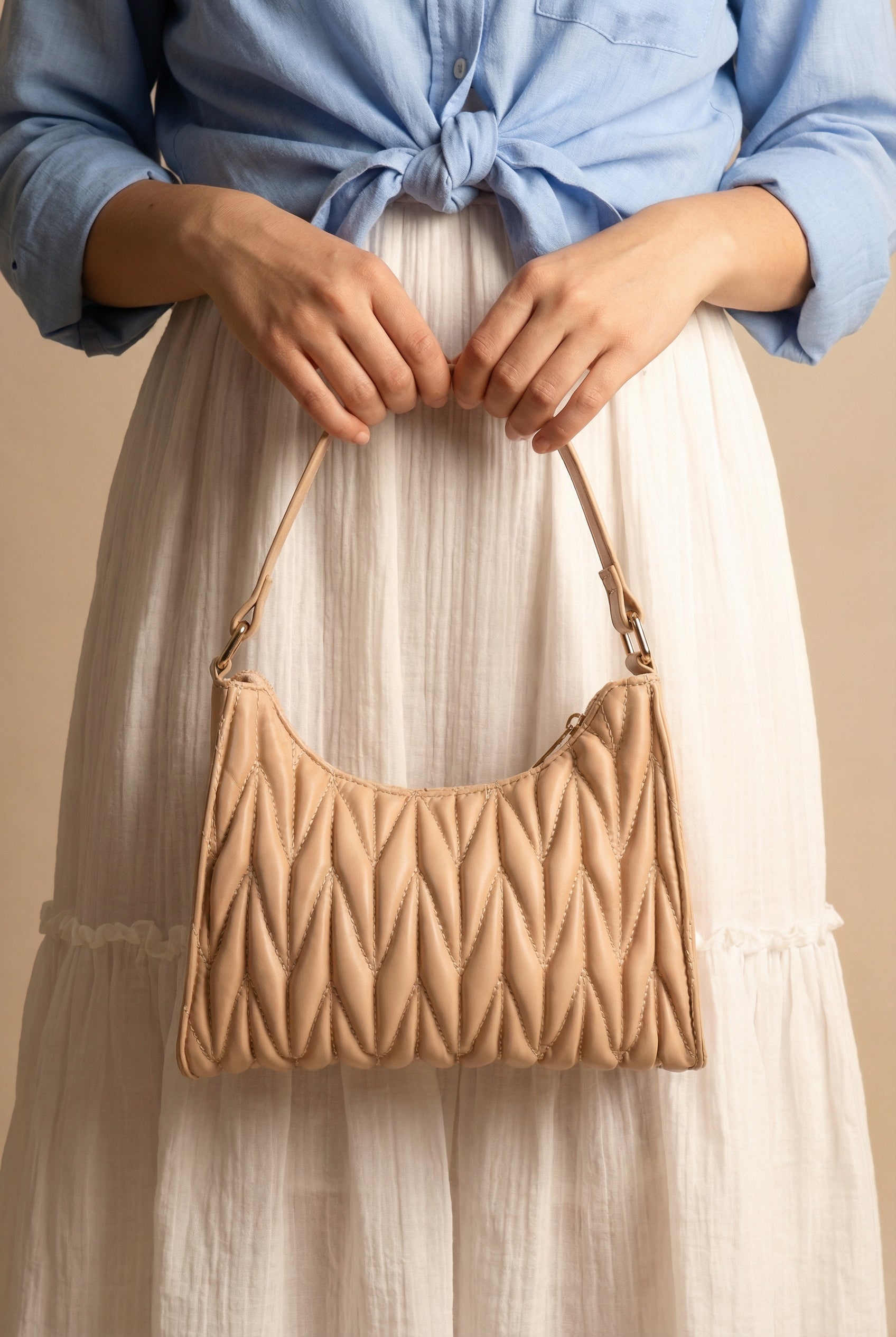 woman showing Roseaux Beige Chevron Quilt Shoulder Bag from La petite garçonne