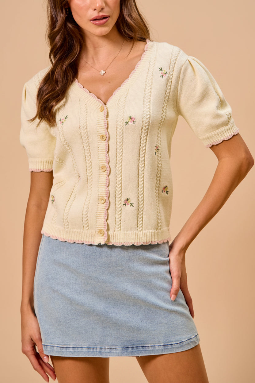 view of a woman wearing Sanae Cream Floral Embroidered Scallop Edge Knit Cardigan from Boutique 1861