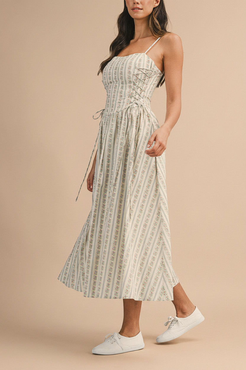 side view of a woman wearing Saratou Floral Stripe Maxi Dress with Side Lace-Up Detail from Boutique 1861