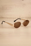 Profile view of Solstice Gold Oval Sunglasses with Brown Lenses at la petite garçonne