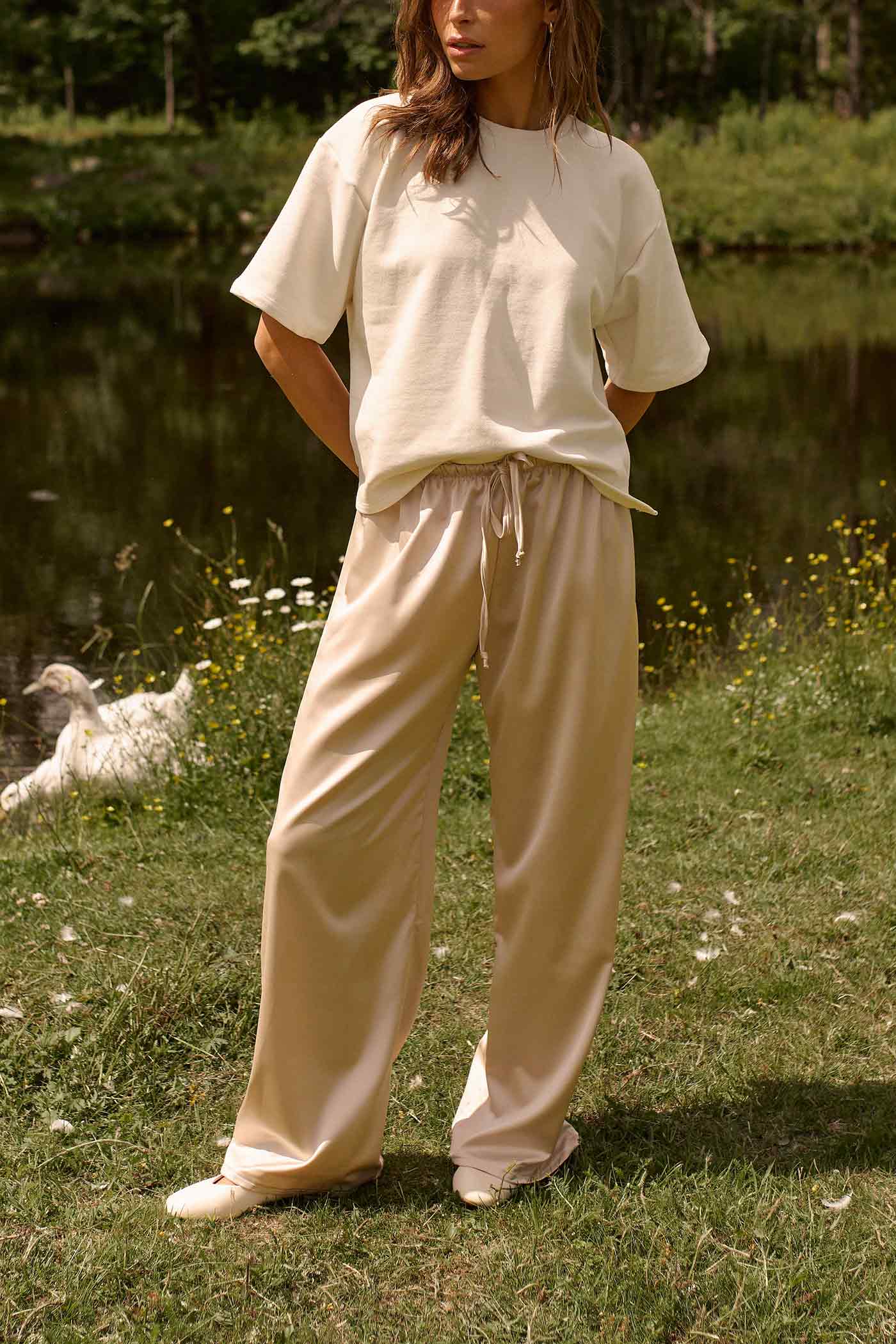 woman wearing Anae Top Ivory Oversized Short Sleeve T-Shirt by Dailystory from La petite garçonne
