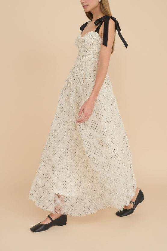 side view of a woman wearing Takako Long White Tulle Dress with Black Polka Dots from Boutique 1861