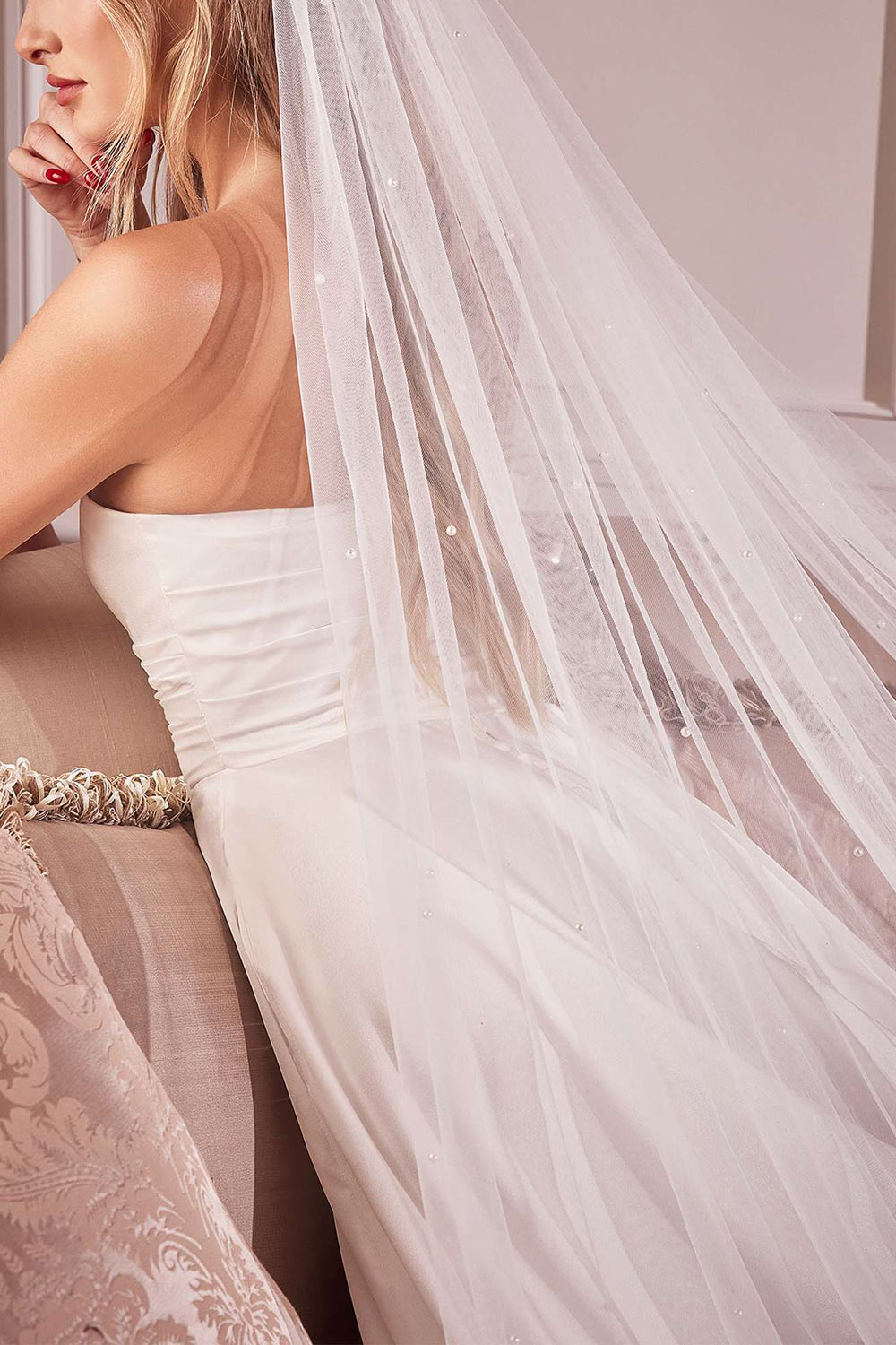 close-up of a woman wearing Trisha Royal Length White Veil with Pearls from Boudoir 1861