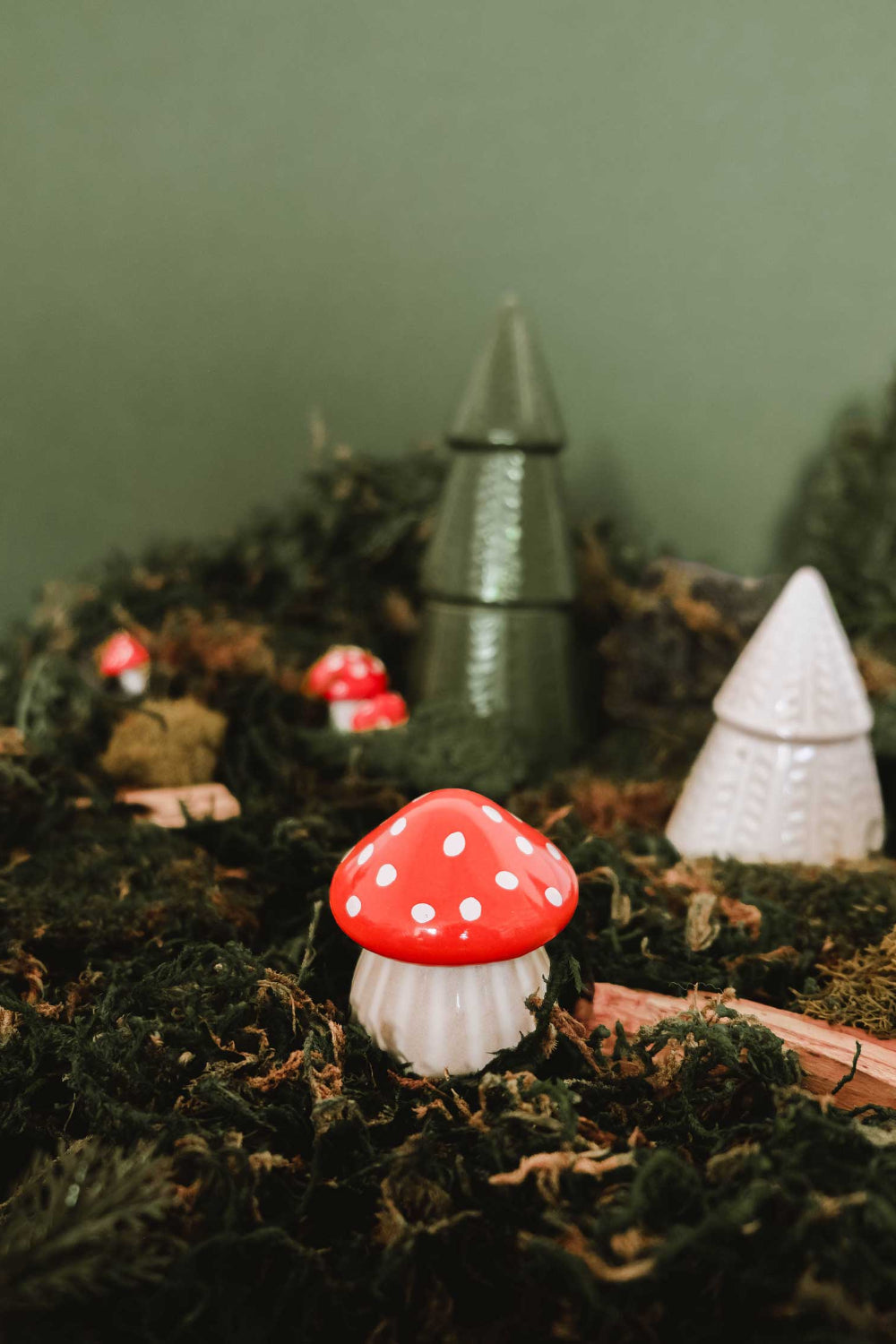 Decorative christmas little mushrooms candle with red spots on a bed of moss by Mimi & August
