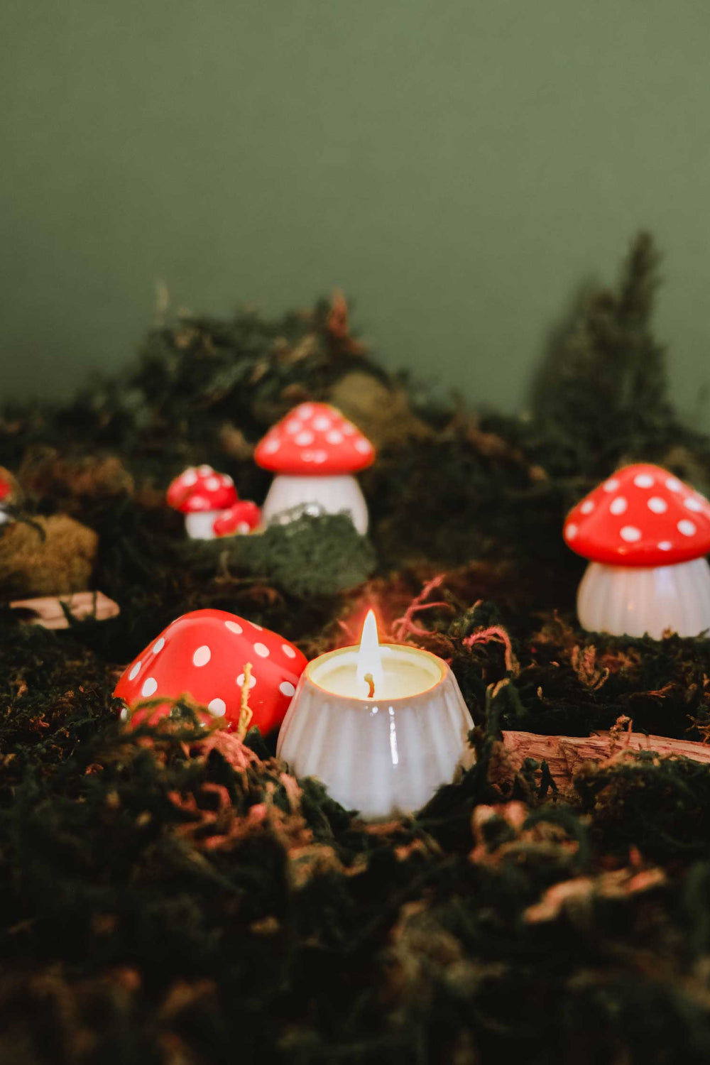 Decorative christmas little mushrooms candle with red spots on a bed of moss by Mimi & August