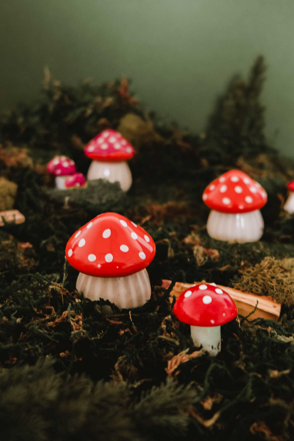 Decorative christmas little mushrooms candle with red spots on a bed of moss by Mimi & August