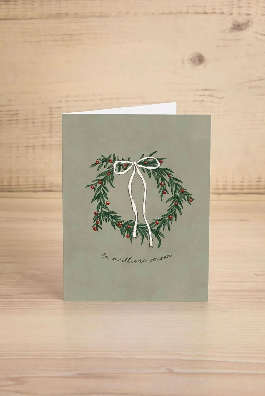 Christmas Sage green card grom Mimi & August with a festive wreath design and text on a white background