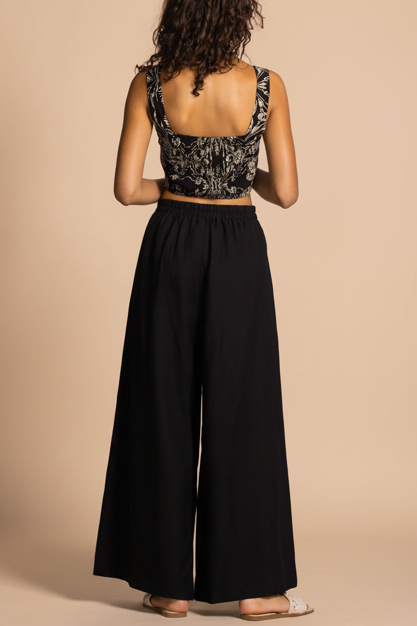 back view of a woman wearing Varallo Black Wide Leg Pants with Front Pleats from La petite garçonne