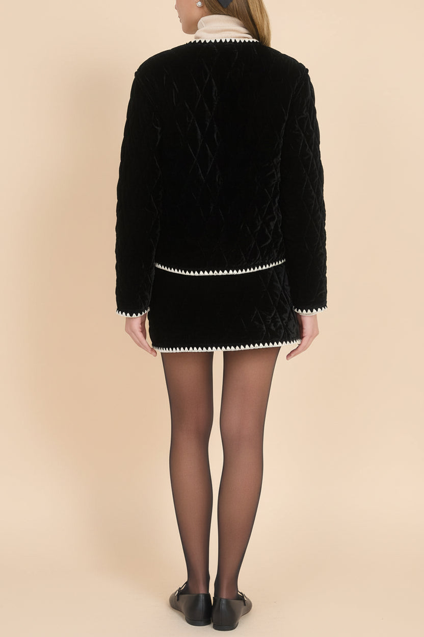 back view of a woman Vicenza Black Velvet Quilted Vest with Scalloped Trim from Boutique 1861