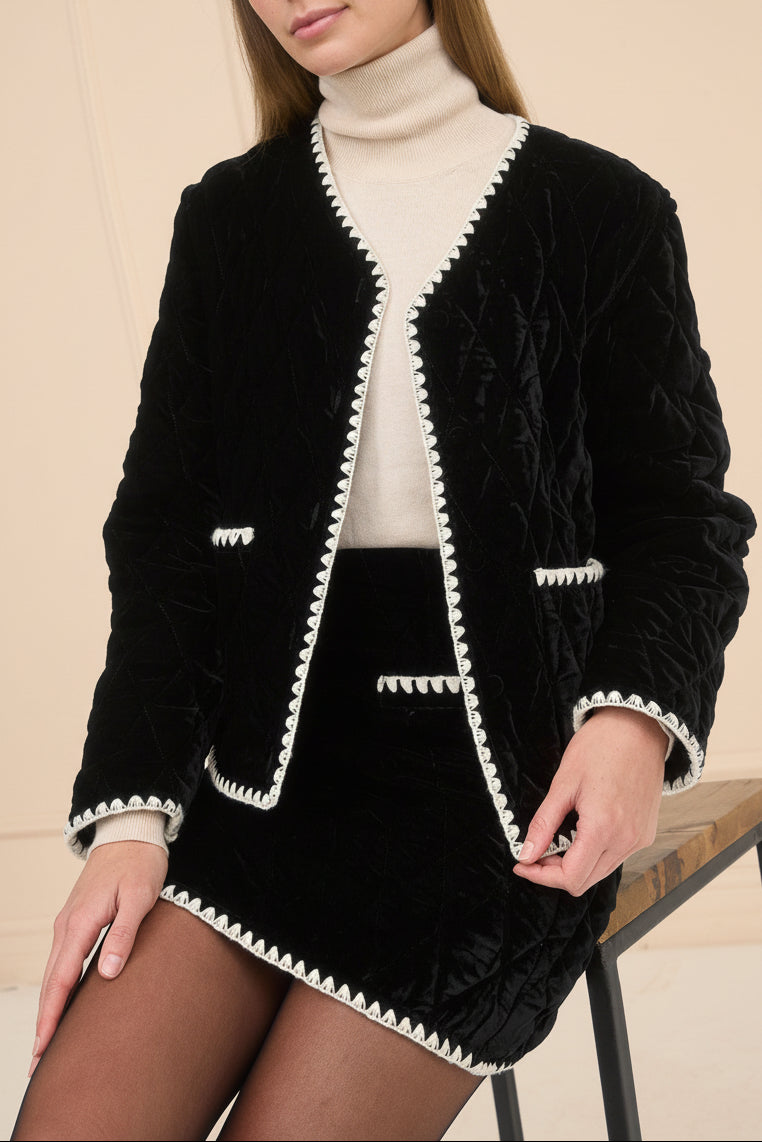 view of a woman wearing Verana Black Velvet Mini Skirt with White Trim from Boutique 1861