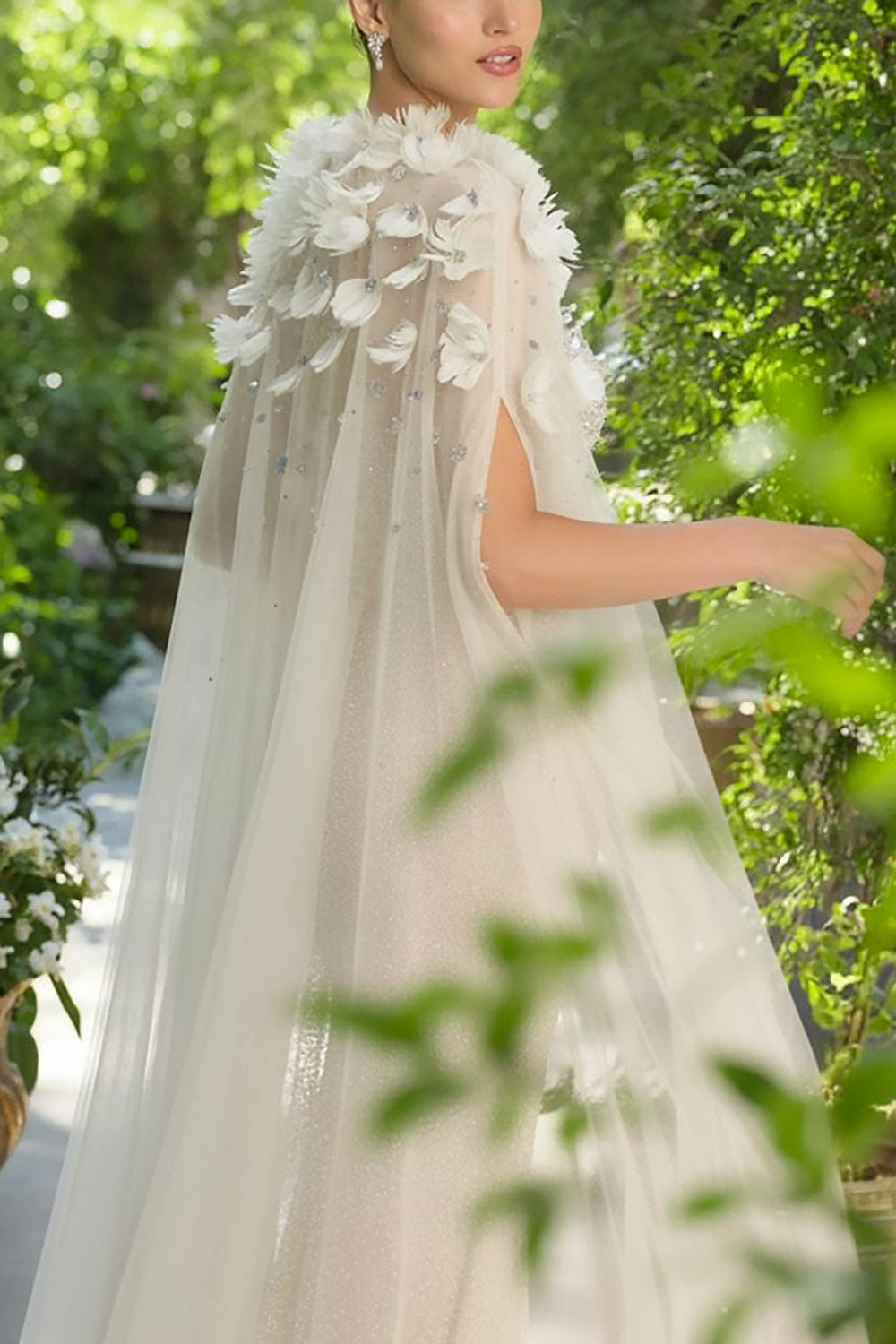 close-up of a woman wearing Volina Ivory Floral Embroidered Tulle Cape with Feathers | Boudoir 1861