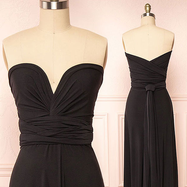 Two black dresses on mannequins against a light pink background