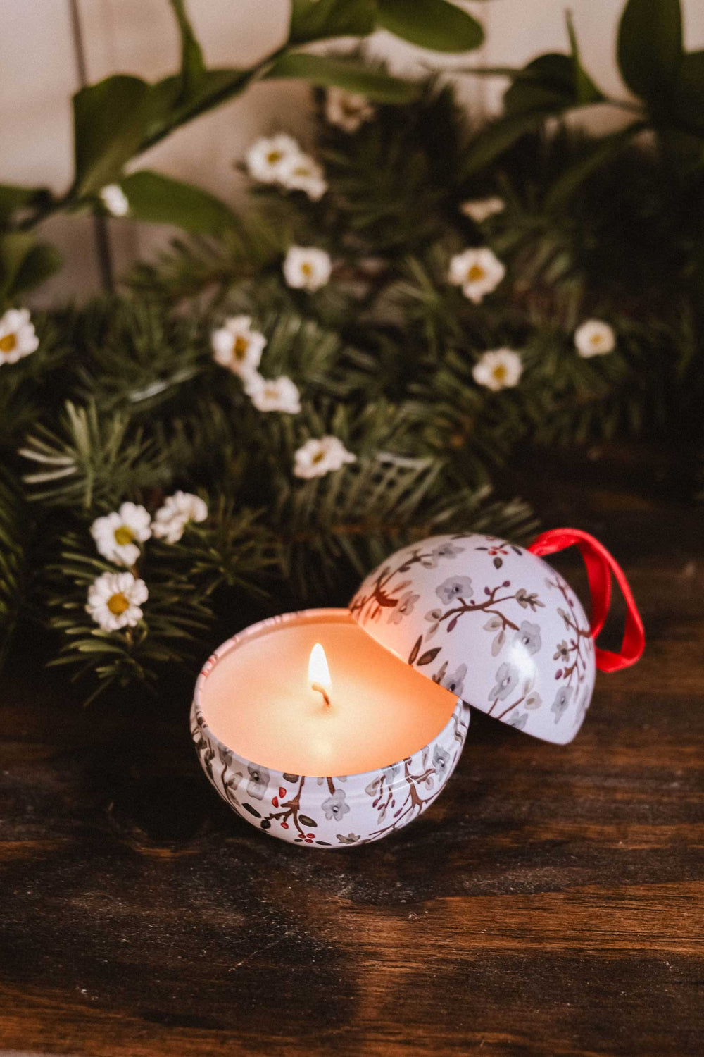 Decorative Winter Flower Christmas candle ornament with floral pattern on a wooden surface with greenery by Mimi & August