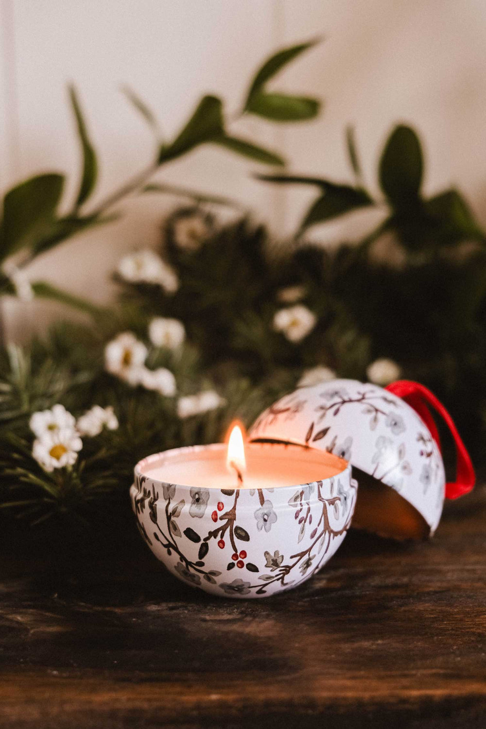 Decorative Winter Flower Christmas candle ornament with floral pattern on a wooden surface with greenery by Mimi & August
