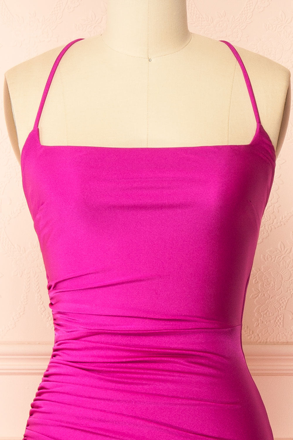 front of a sewing mannequin wearing the Akari Fuchsia Mermaid Maxi Dress from boutique 1861