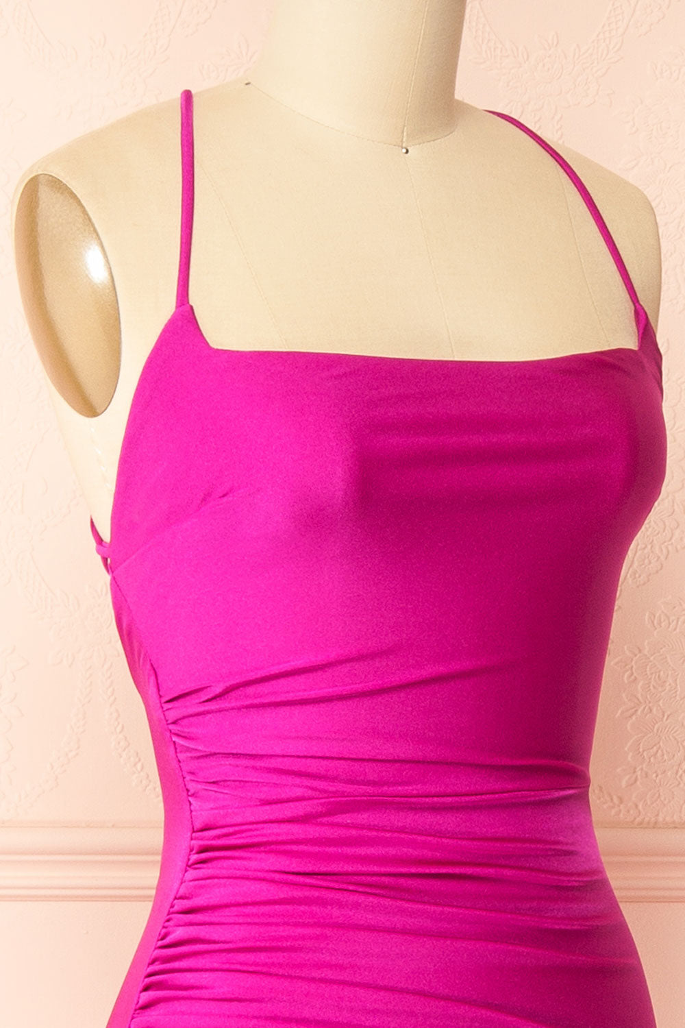 side of a sewing mannequin wearing the Akari Fuchsia Mermaid Maxi Dress from boutique 1861