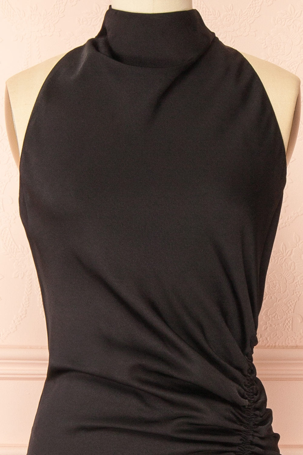 front of a sewing mannequin wearing the Alberta Black Maxi Dress with a high neckline from Boutique 1861.