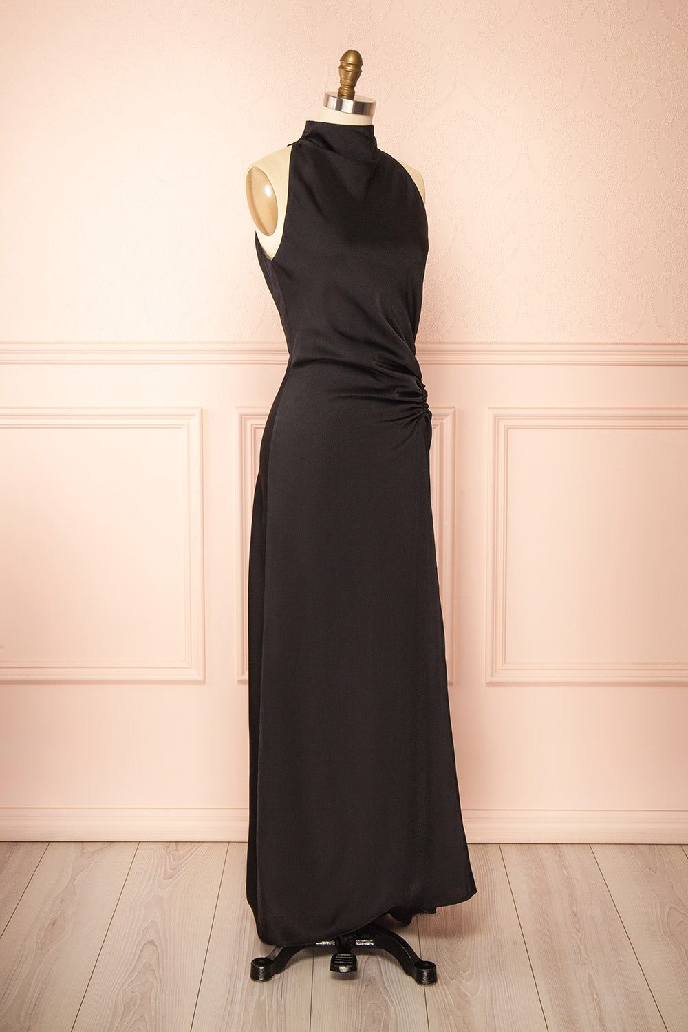 side view of a sewing mannequin wearing the Alberta Black Maxi Dress with a high neckline from Boutique 1861.