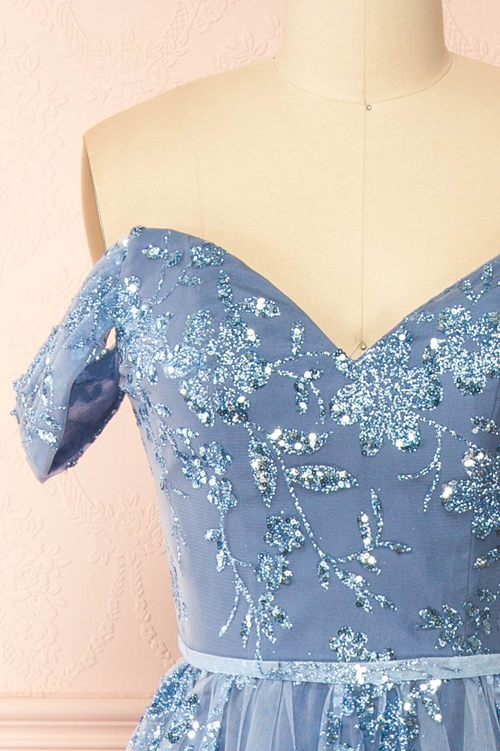 front of sewing mannequin wearing Alienor Blue Grey Glittery Off the Shoulder Maxi Dress from Boutique 1861