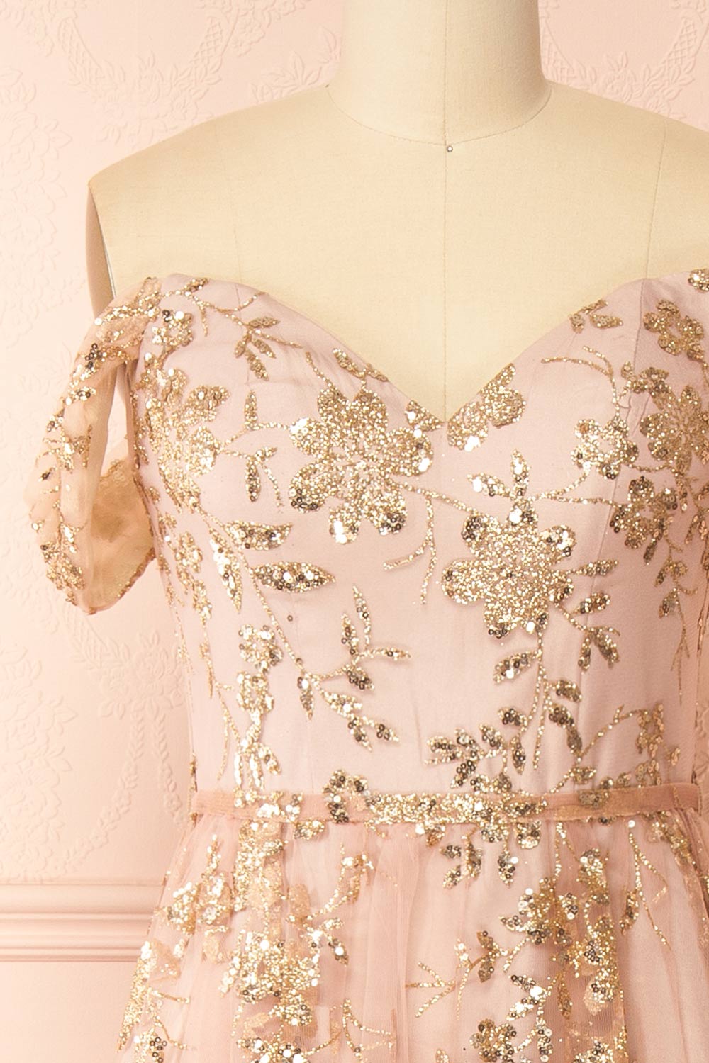 front of sewing mannequin wearing Alienor Taupe Glittery Off the Shoulder Maxi Dress from Boutique 1861