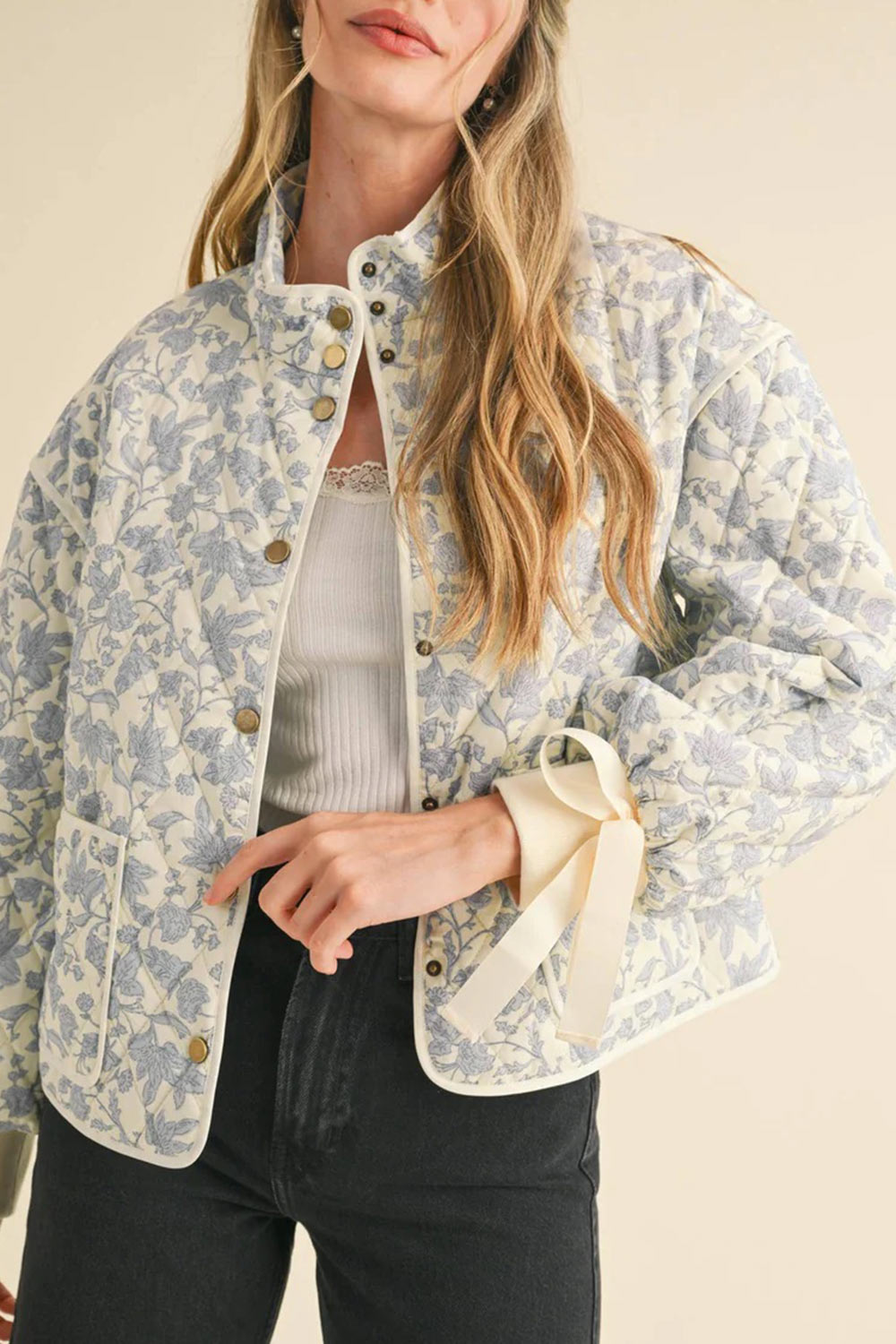 close-up of a woman wearing Anabeth Blue Floral Quilted Jacket with Ribbon-Tied from Boutique 1861