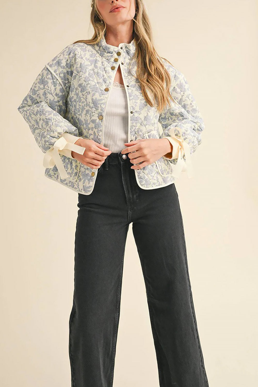 front of a woman wearing Anabeth Blue Floral Quilted Jacket with Ribbon-Tied from Boutique 1861