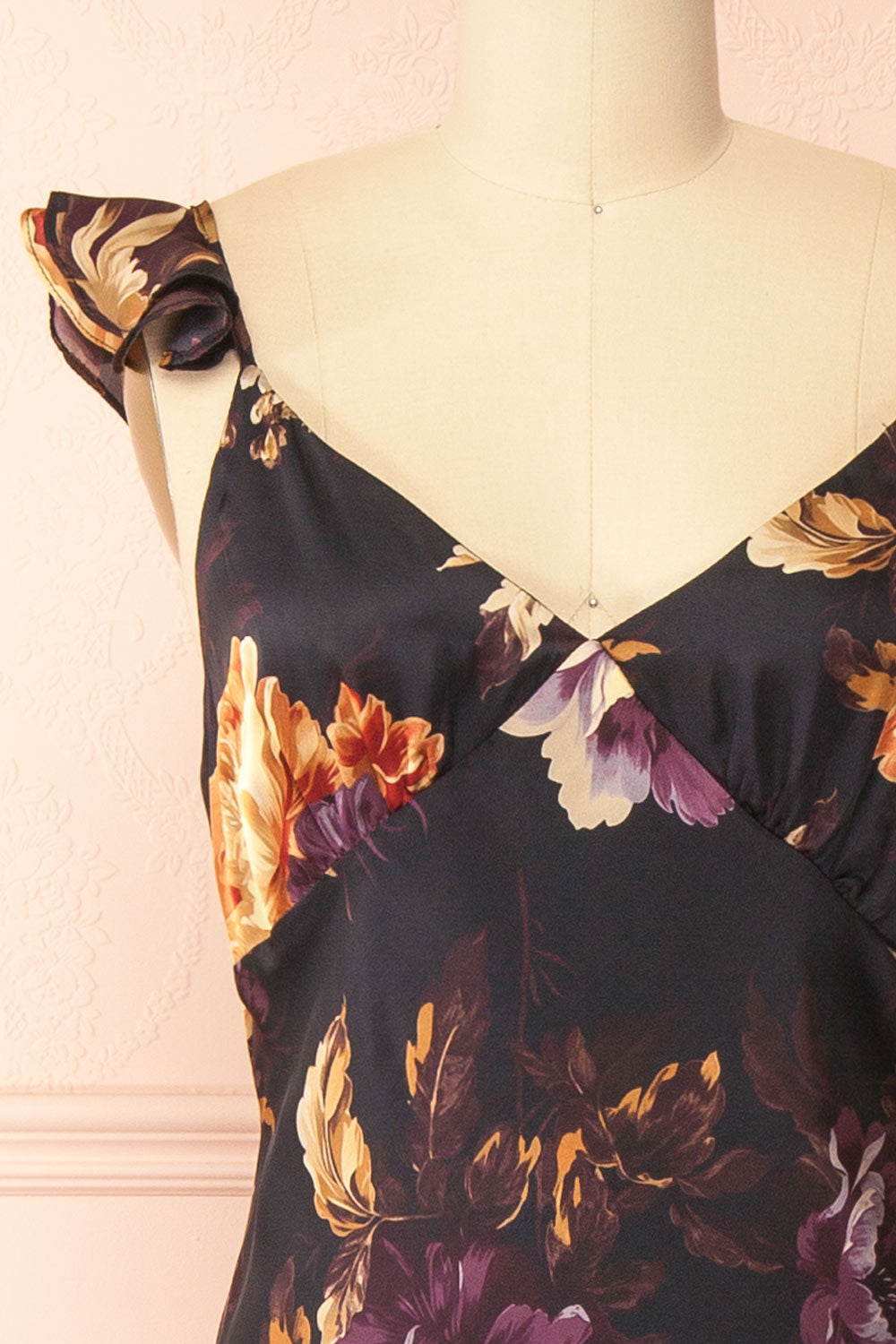 front of a sewing mannequin wearing the Angella Floral Satin Dress from Boutique 1861