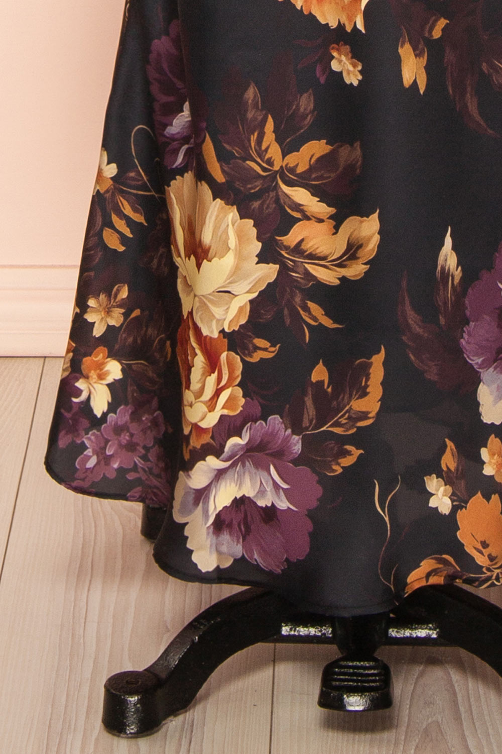 bottom of a sewing mannequin wearing the Angella Floral Satin Dress from Boutique 1861