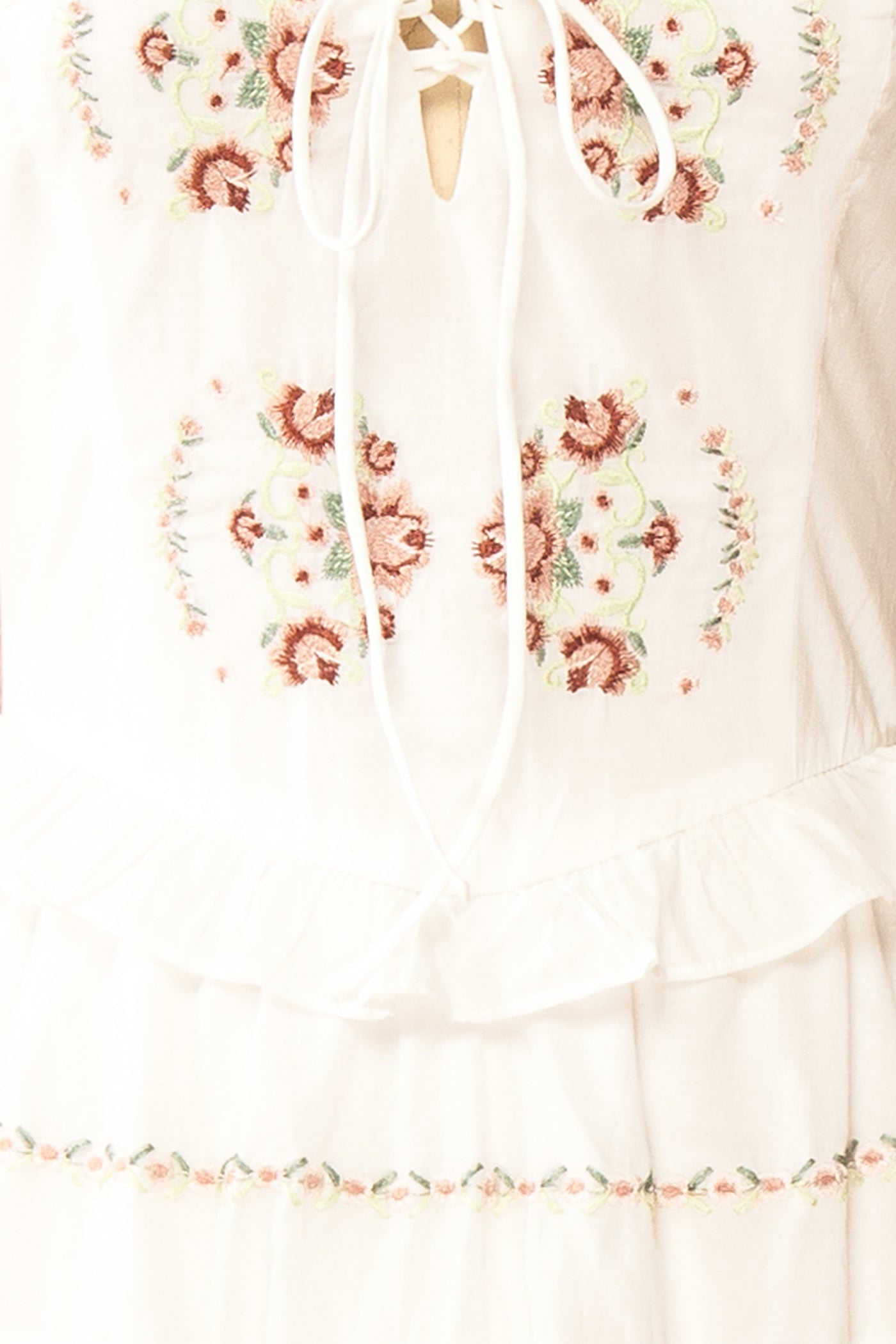 Close-up view Aspyn White Floral Embroidered Midi Dress with Smocked Back at boutique 1861