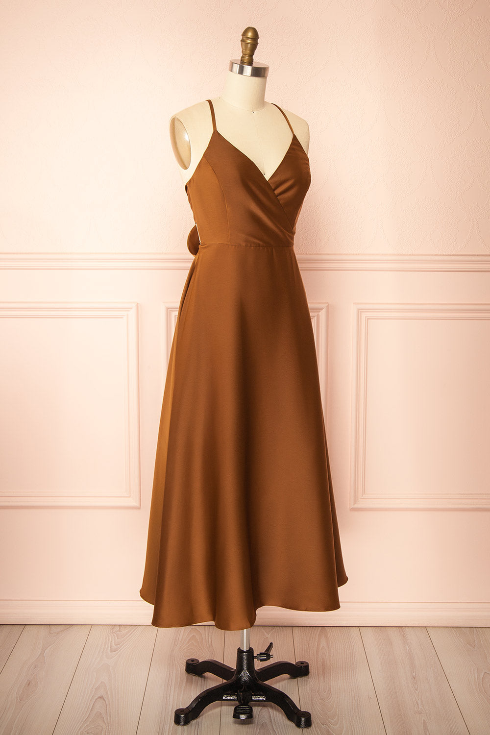side view of a mannequin wearing the Caryanne Brown Tie-Back Satin Dress from Boutique 1861