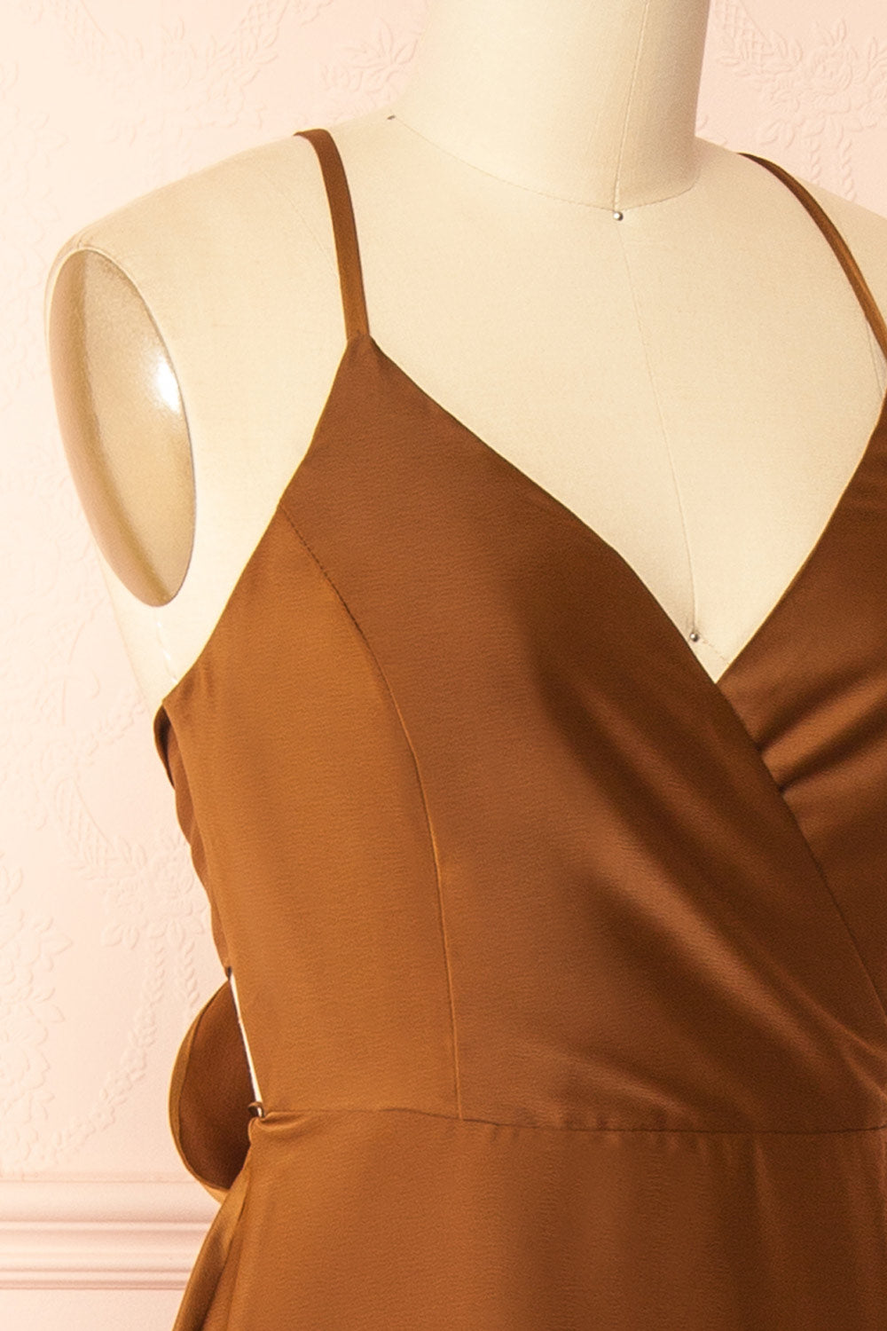 side of a mannequin wearing the Caryanne Brown Tie-Back Satin Dress from Boutique 1861
