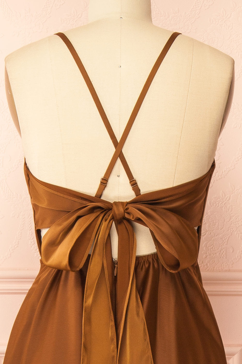 back of a mannequin wearing the Caryanne Brown Tie-Back Satin Dress from Boutique 1861