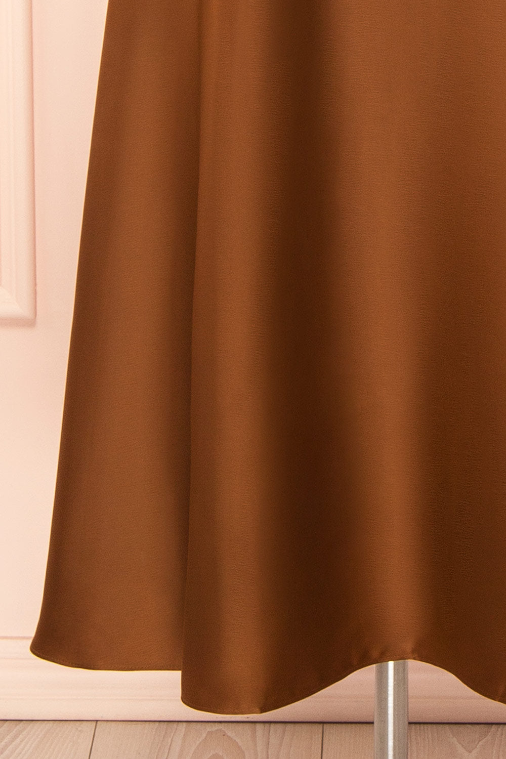 bottom of a mannequin wearing the Caryanne Brown Tie-Back Satin Dress from Boutique 1861