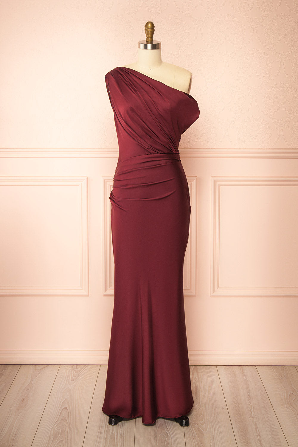 front view of mannequin wearing Colleen Burgundy Asymmetrical Satin Dress from boutique 1861