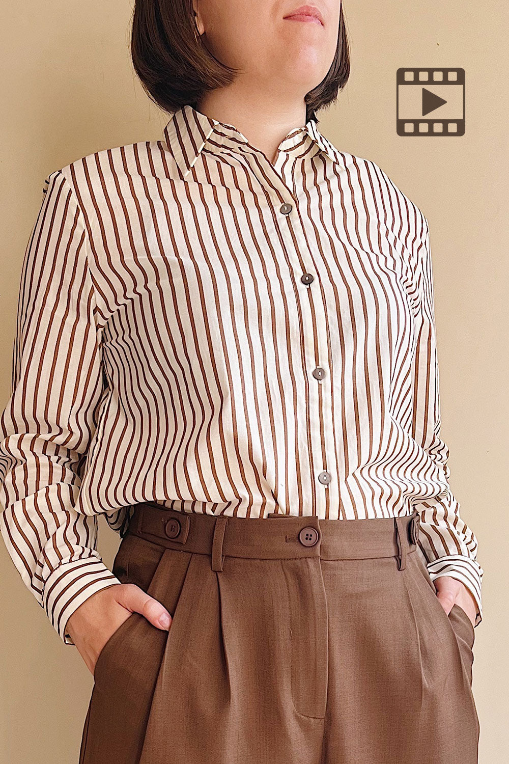 Model wearing the brown and white striped shirt Safire with brown pants
