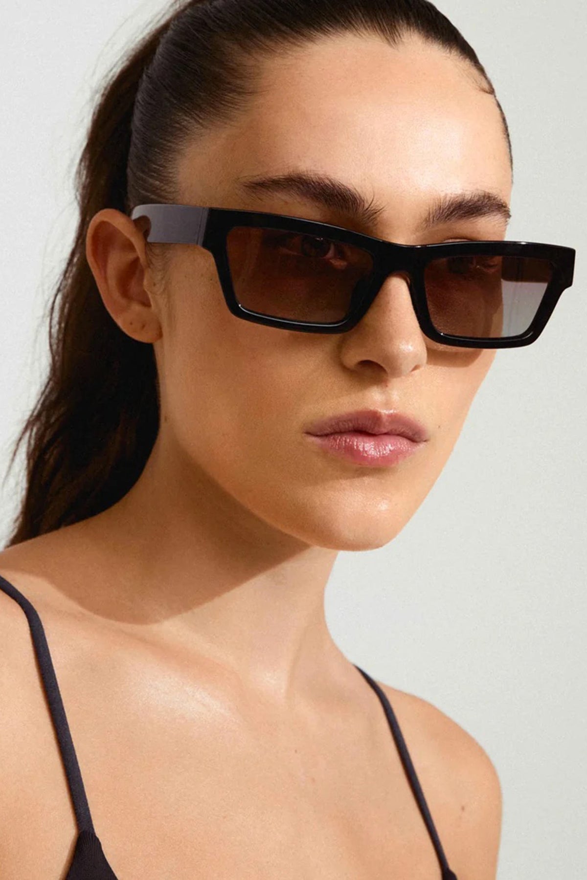 a woman wearing Crema Black Rectangle Frame Sunglasses by Pilgrim from La petite garçonne