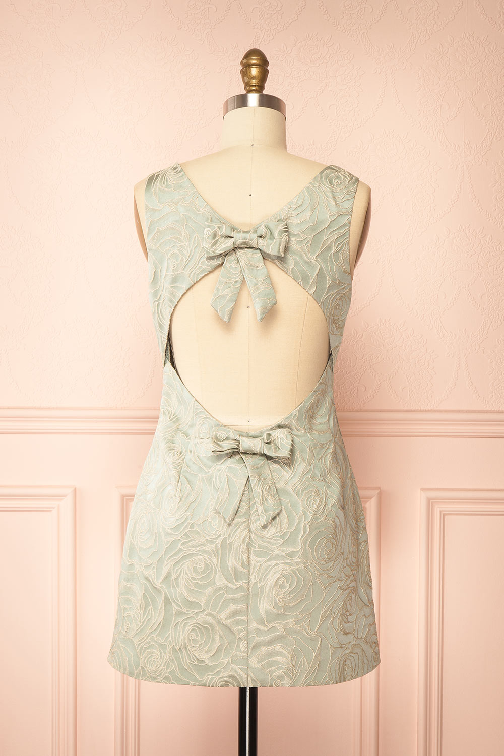 back view of a mannequin wearing a Daenna Sage Short Floral Embroidered Dress from boutique 1861