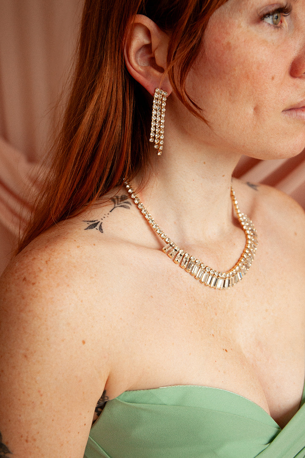woman wearing Emirina Gold Crystal Earrings and Necklace Set from Boutique 1861