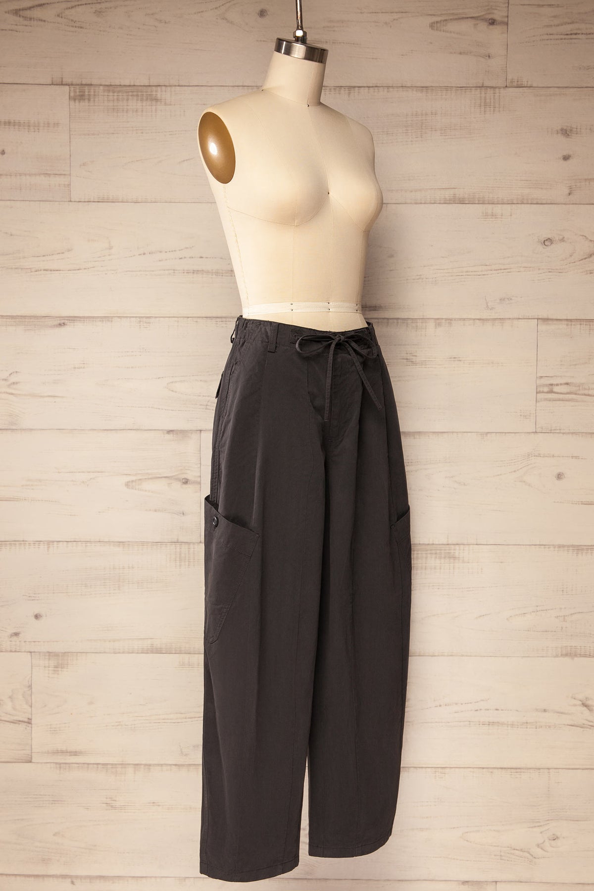side view of Esker Dark Grey Barrel Leg Cargo Pants with Drawstring at La petite garçonne