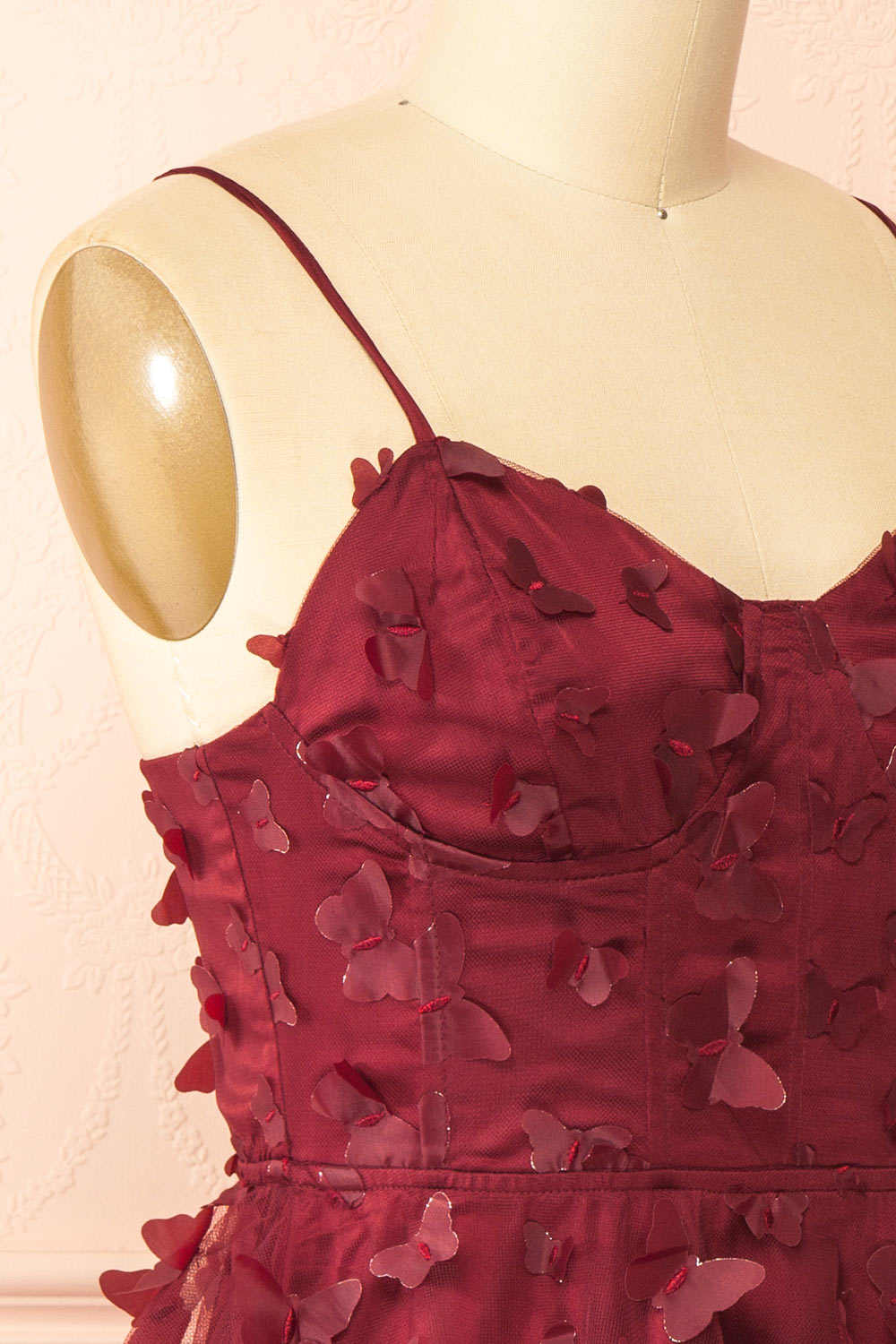 side of a sewing mannequin wearing Faya Burgundy Short Corset Dress with Butterflies from Boutique 1861