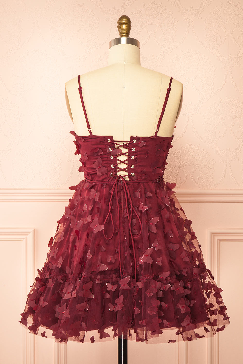 back view of a sewing mannequin wearing Faya Burgundy Short Corset Dress with Butterflies from Boutique 1861