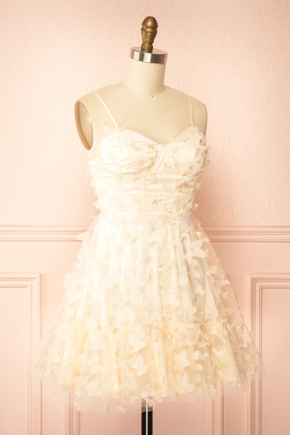 side view of sewing Mannequin wearing Faya Ivory Short Corset Dress with Butterflies From Boutique 1861