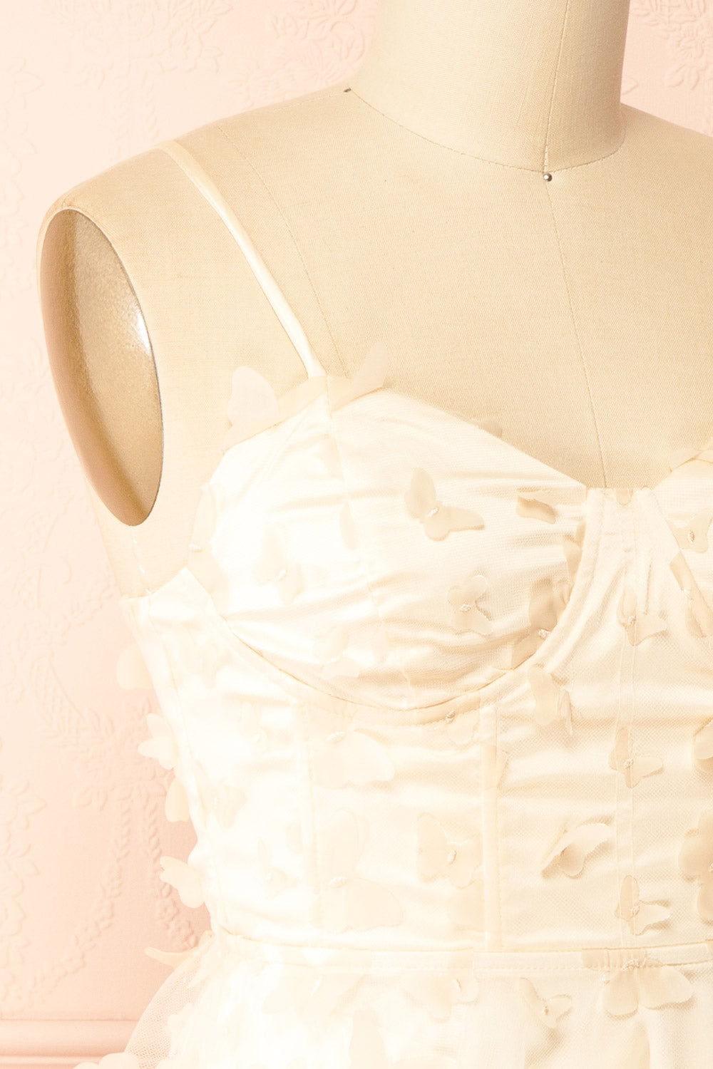 side of sewing Mannequin wearing Faya Ivory Short Corset Dress with Butterflies From Boutique 1861