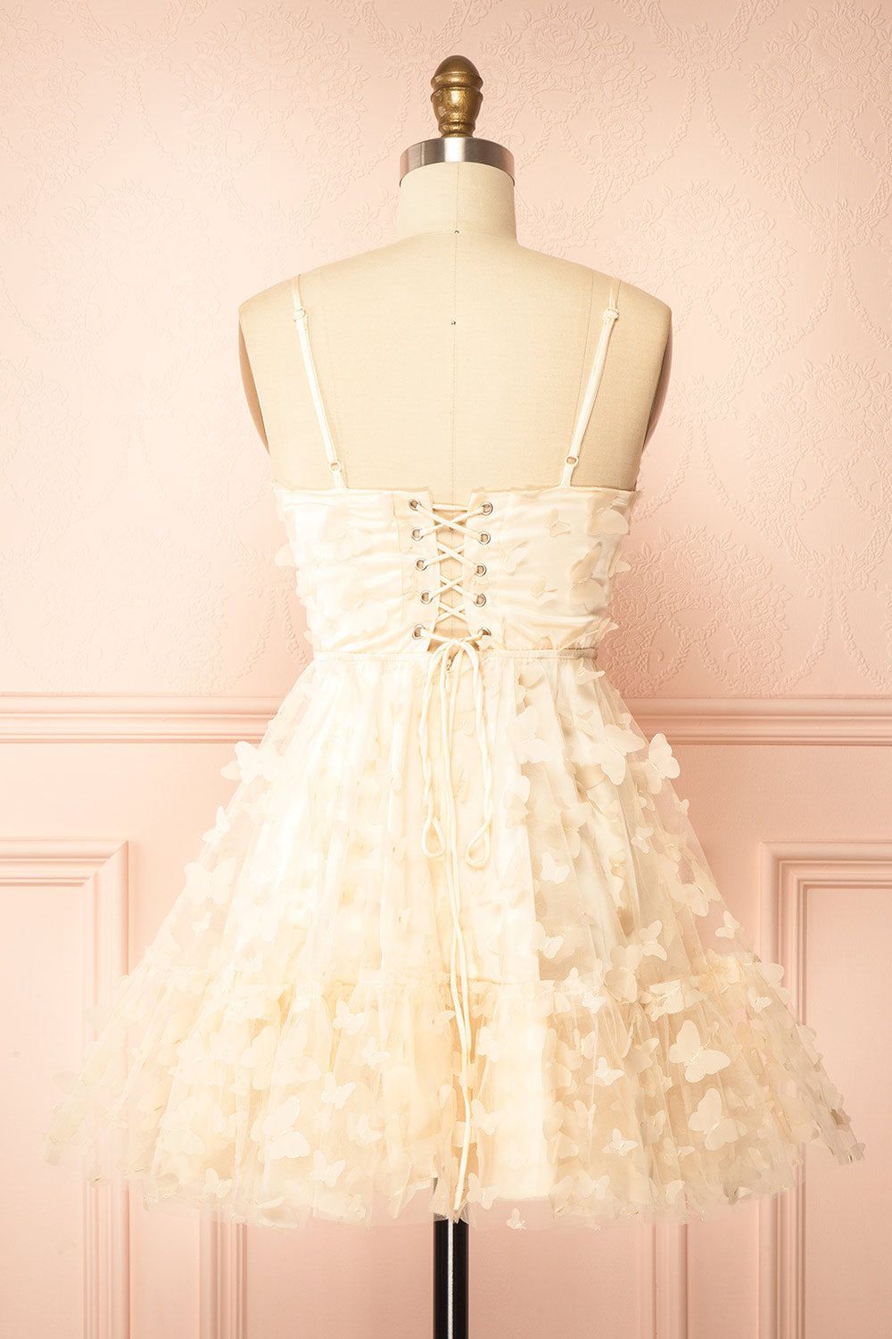 back view of sewing Mannequin wearing Faya Ivory Short Corset Dress with Butterflies From Boutique 1861