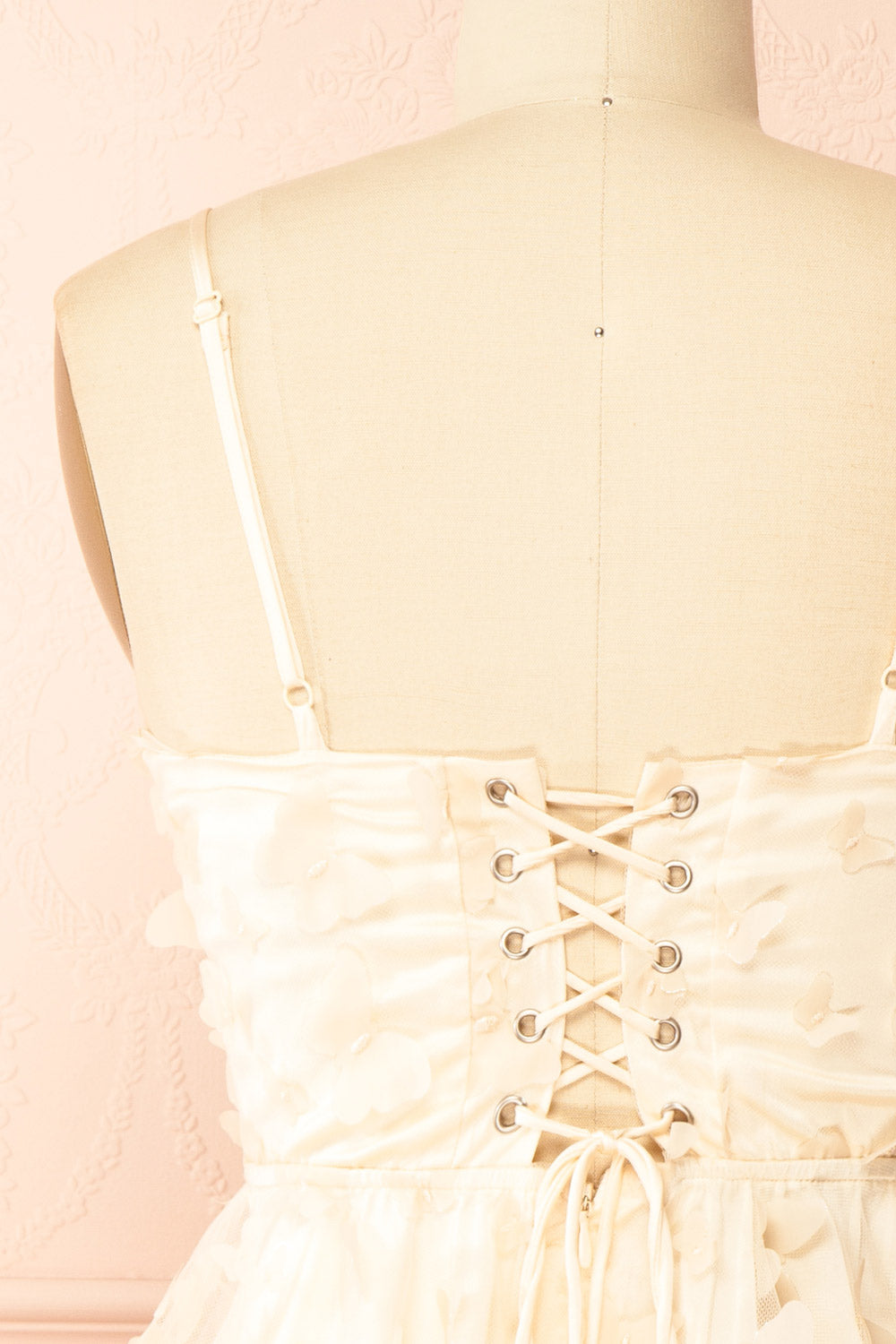back of sewing Mannequin wearing Faya Ivory Short Corset Dress with Butterflies From Boutique 1861