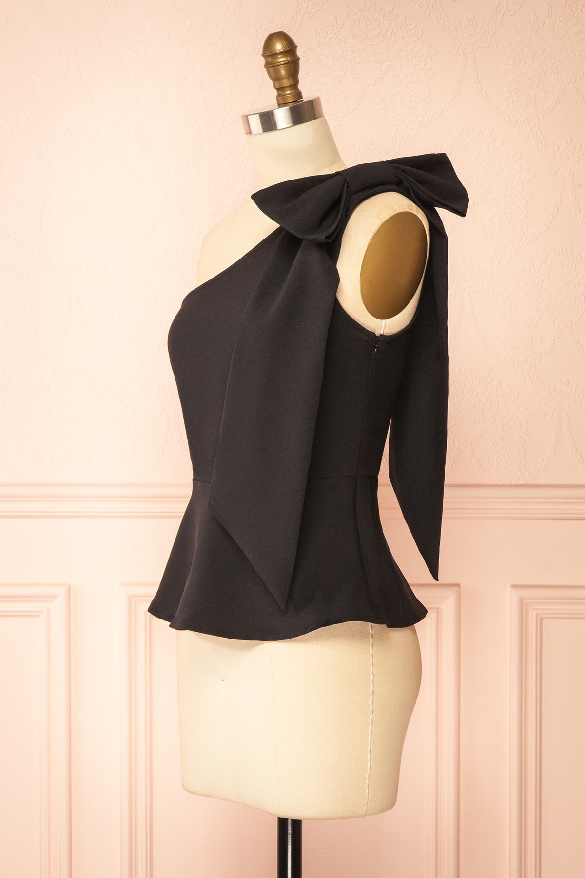 Side view of Galiote Black One-Shoulder Bow Peplum Top at Boutique 1861