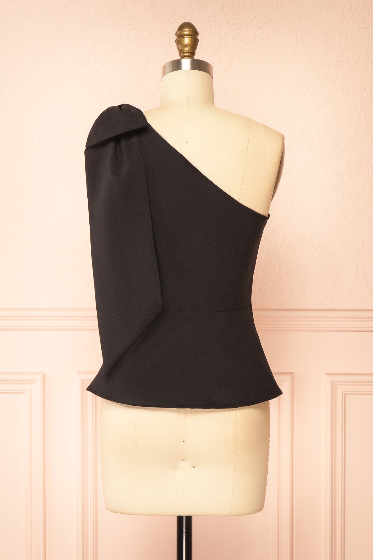Back view of Galiote Black One-Shoulder Bow Peplum Top at Boutique 1861
