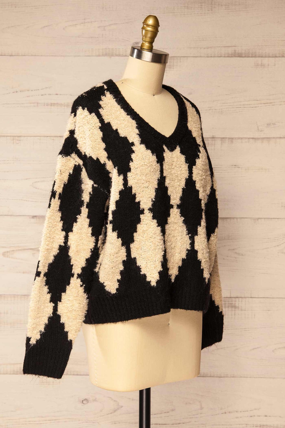 side view of Gawler Black Oversized Argyle V-Neck Knit Sweater at La petite garçonne